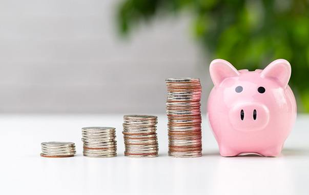 Coins next to a piggy bank