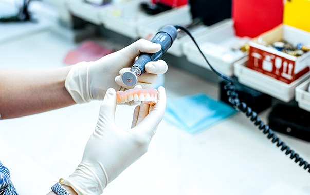 A lab technician making dentures