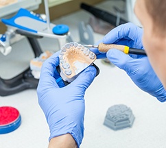 A technician working on denture materials