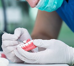 A lab worker creating dentures