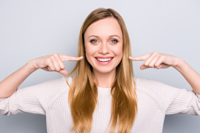 patient smiling while talking to cosmetic dentist 